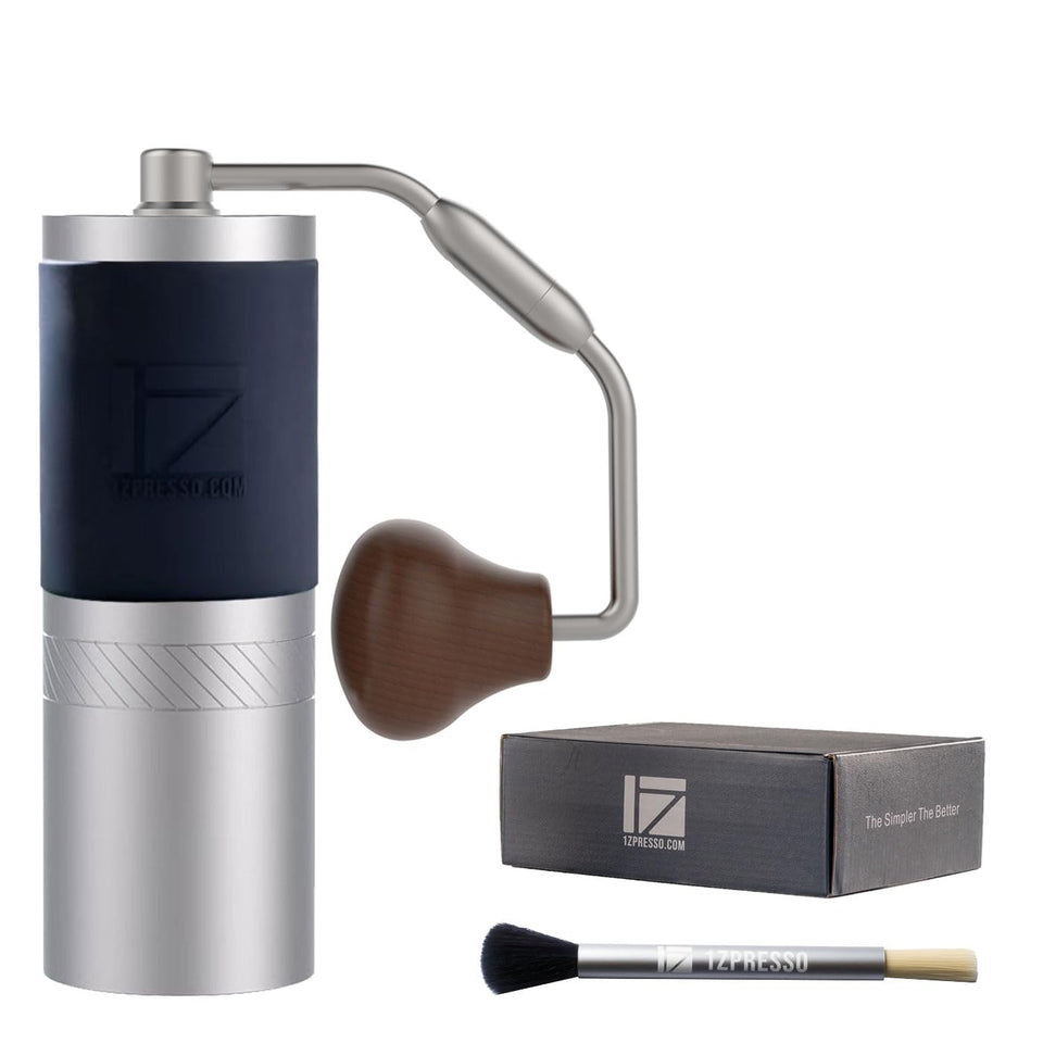 1Zpresso J Manual Coffee Grinder in silver, side view for travel-friendly prep.
