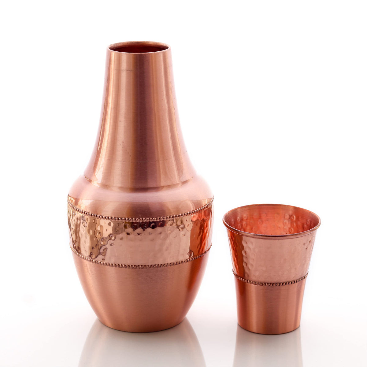 2activelife bedside copper carafe beside a glass for nighttime hydration.