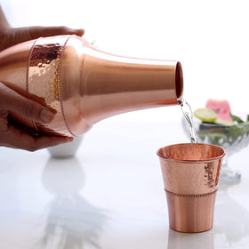 2activelife handcrafted copper carafe and tumbler pair on a shelf.