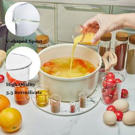 Ackers BORO3.3 glass measuring cups show clear scale markings for ml, oz, and tsp accuracy.