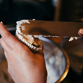 Acronde 10-inch straight icing spatula for tall cake decorating tasks.