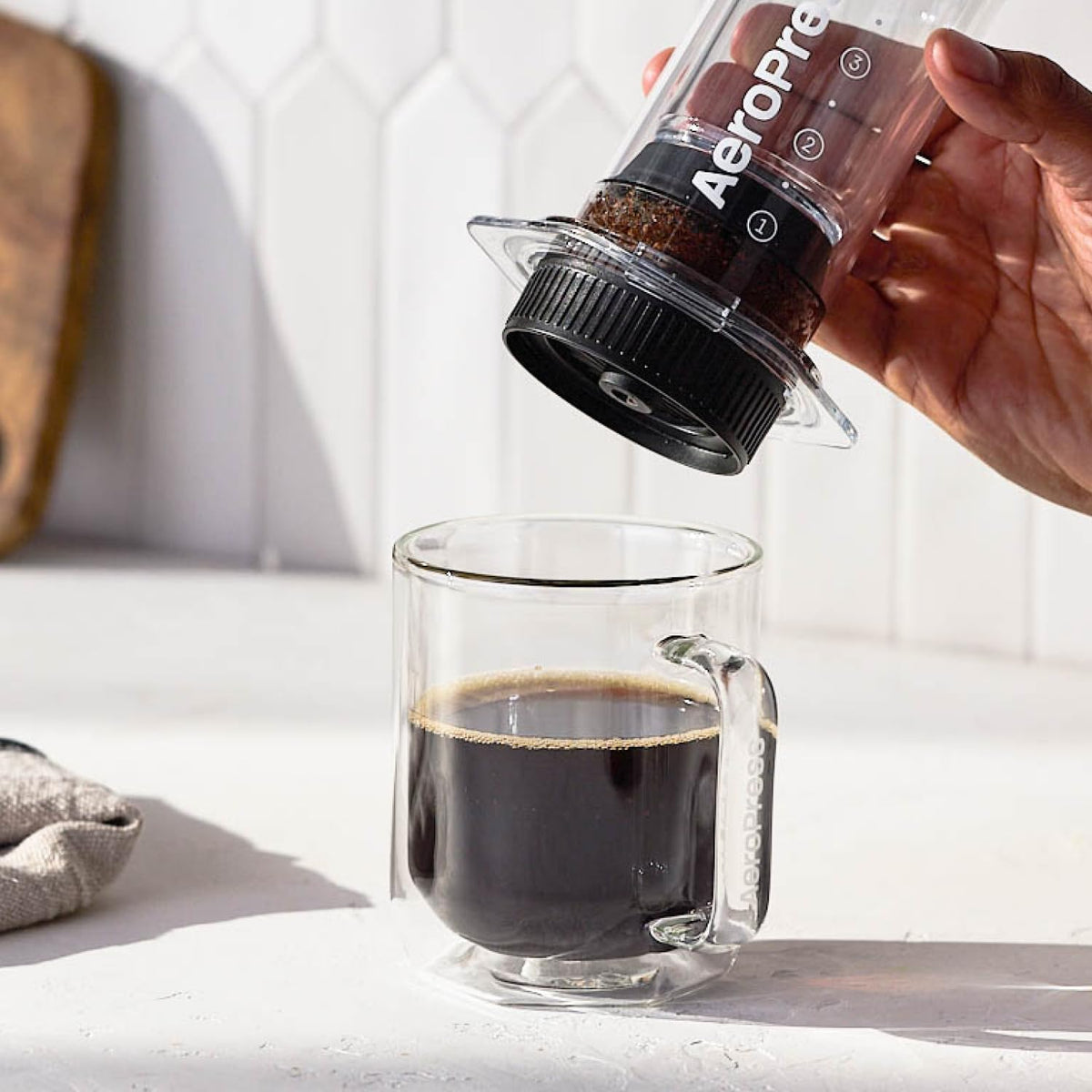 AeroPress Flow Control Cap on AeroPress shows versatile brewing with optional filters.