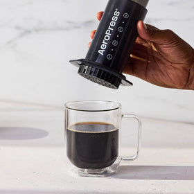 AeroPress Original travel use case showing portable, durable design for coffee on the road.
