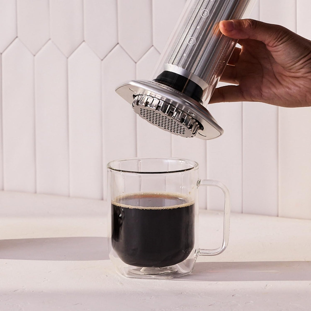 AeroPress Premium coffee scoop with built-in stirring tool for quick measurements.
