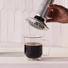 AeroPress Premium coffee scoop with built-in stirring tool for quick measurements.