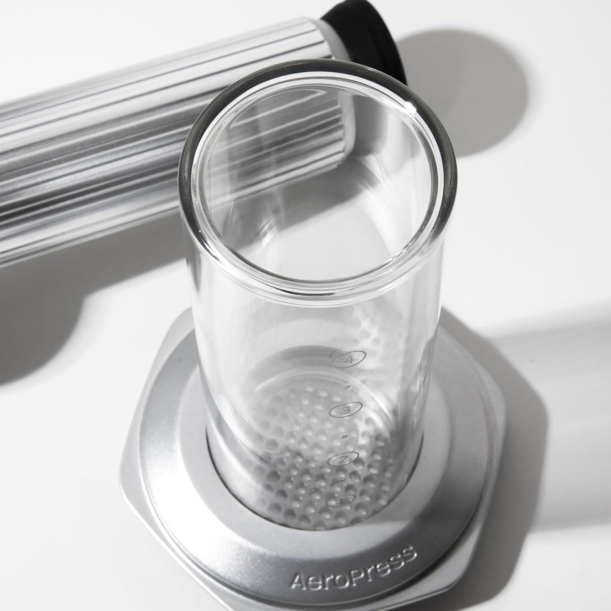 AeroPress Premium stirrer shown beside the press during setup.