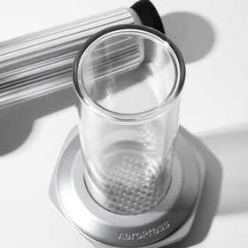 AeroPress Premium stirrer shown beside the press during setup.