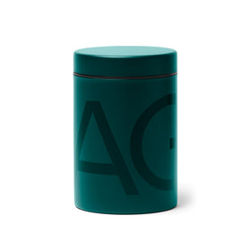 AG1 canister in deep green with a wide-mouth opening for easy scooping