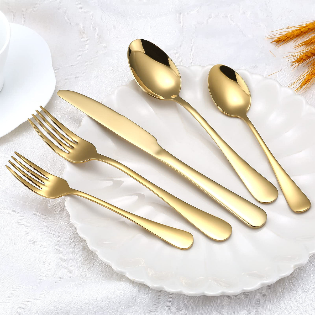 Aisoso gold flatware set mirror-finish closeup showing premium plating and shine.
