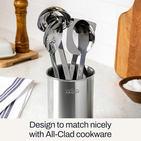 All-Clad solid spoon with ergonomic handle for versatile stirring.