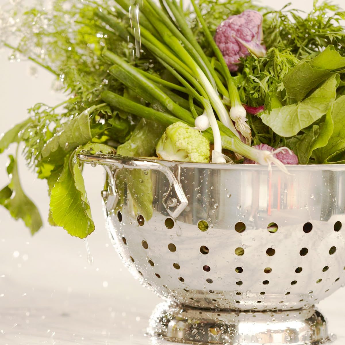 All-Clad colander dishwasher-safe with pedestal base ensures stable cleaning and draining.