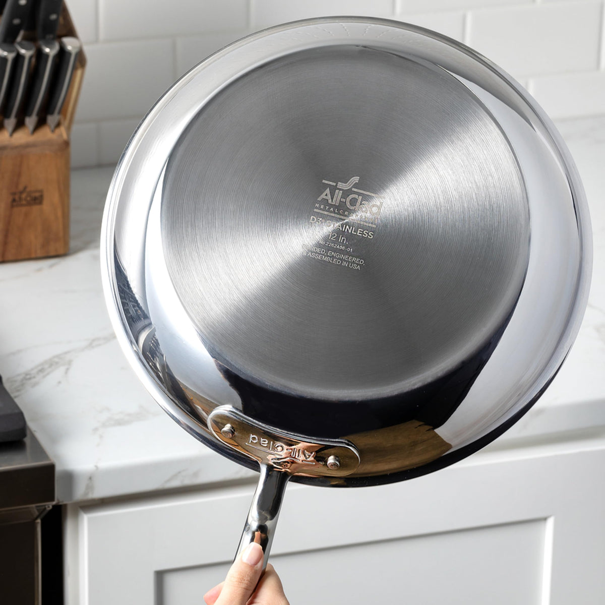 All-Clad D3 double-riveted handles provide a secure grip during stirring.