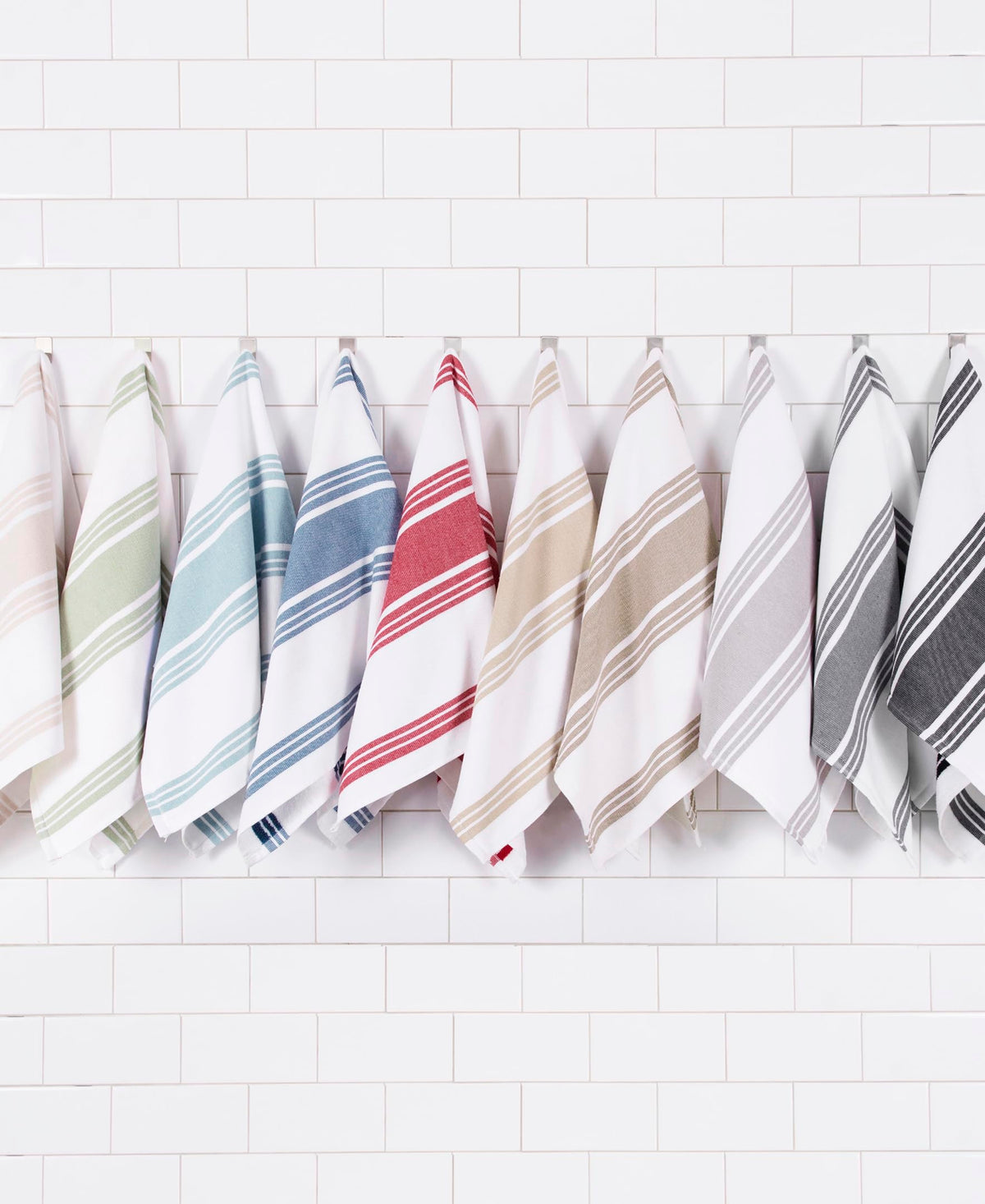 All-Clad towels folded on counter show full size and softness.