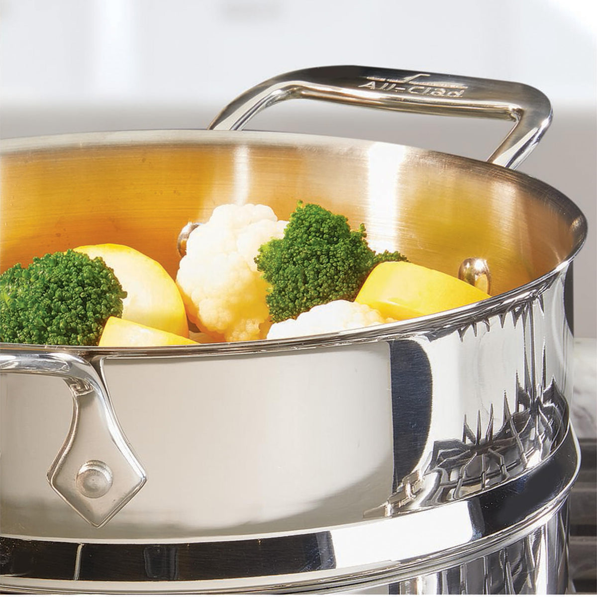 All-Clad E414S564 steamer handles provide secure grip during draining.