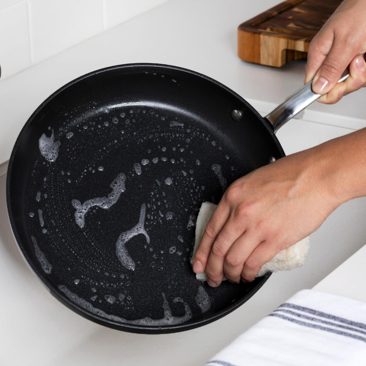 All-Clad HA1 Expert Wok 10-inch handle closeup highlights stay-cool grip and durability.