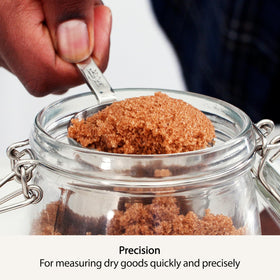 All-Clad measuring cups featuring riveted handles for durable use.