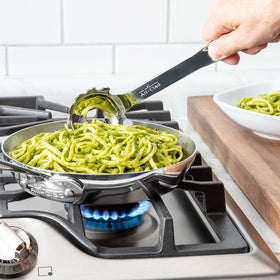 All-Clad stainless steel ladle highlighting large draining holes for clump-free pasta.