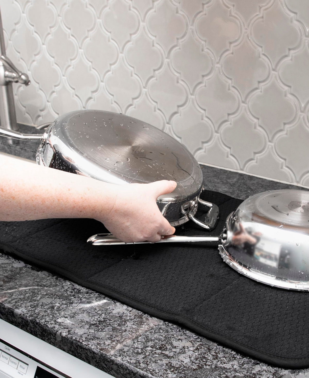 Close up of All-Clad mat soaking moisture from washed dishes