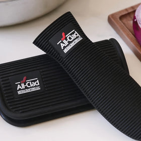 All-Clad silicone grip set shows universal fit on standard cookware handles