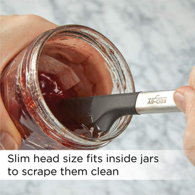 All-Clad silicone tools in action on a stovetop and bowl