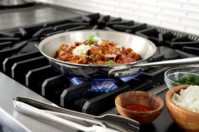 All-Clad stainless steel tongs with ergonomic handles for comfortable use.