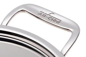 All-Clad steamer insert with handles ready to lift vegetables and seafood