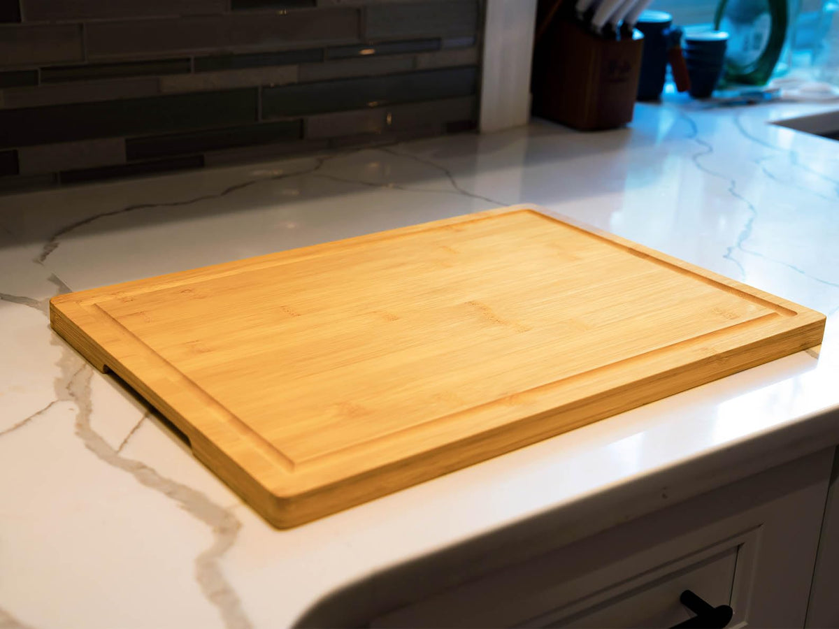 Allsum cutting board inner handle closeup shows easy carrying.