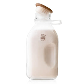 Almond Cow glass pitcher with lid and spout for spill-free pouring.