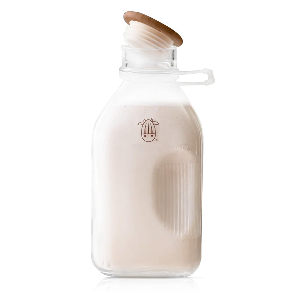 Almond Cow glass pitcher with lid and spout for spill-free pouring.