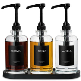 ALPIRIRAL black syrup dispenser set on a stylish coffee bar.