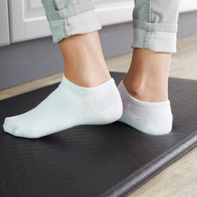 Amazon Basics mat being wiped clean with soap and water for easy maintenance