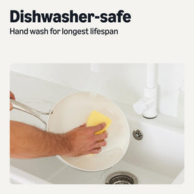 Amazon Basics ceramic nonstick pan with ergonomic stainless steel riveted handles for safe grip.