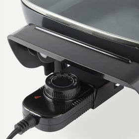 Amazon Basics skillet featuring cool-touch handles for safe lifting and transport
