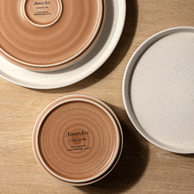 AmorArc dining table mood shot with plates and bowls in natural light.