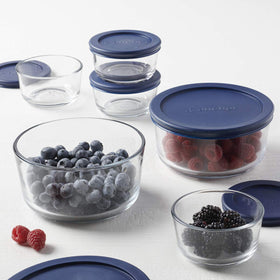 Fridge storage setup with clear glass containers and navy lids visible