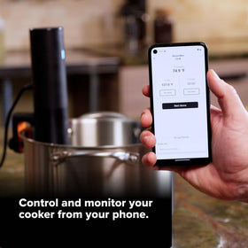 Compact black and orange device attached to pot for even cooking.