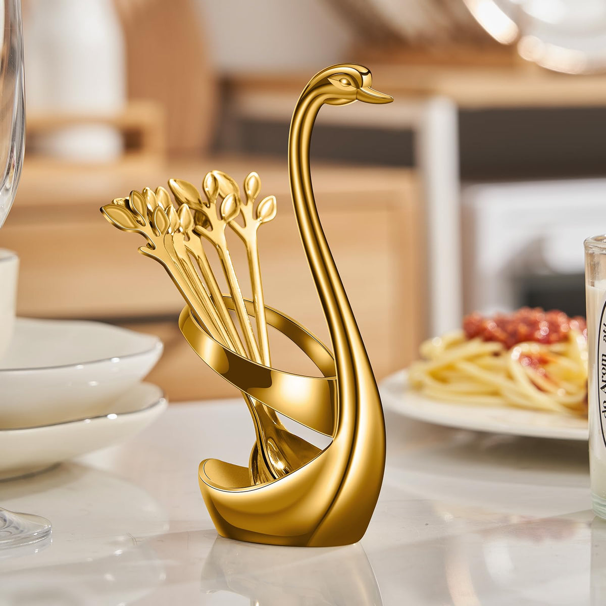 AnSaw gold spoons arranged on a swan base display for organization
