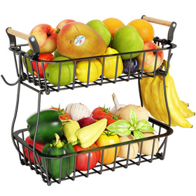 ANTOPY two-tier fruit basket on the counter with banana hangers for easy access.