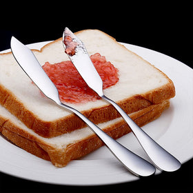 AOOSY spreaders arranged on a cheese board, showcasing versatile use for appetizers.