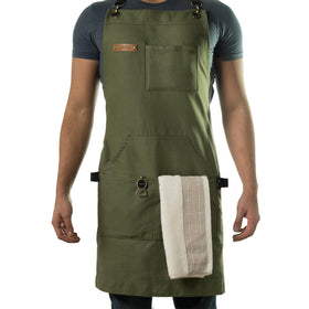 Asaya cross-back apron with green straps for all-day cooking comfort