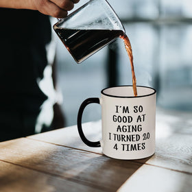 Aurahouse 80th birthday mug - quote print close-up, sparks laughter at gatherings.