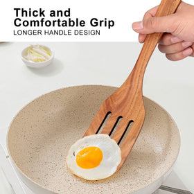Ayiaren teak slotted spatula allowing steam to escape while turning food