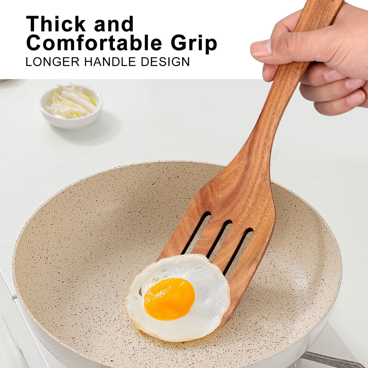 Ayiaren teak spatula slotted for draining liquids while cooking.