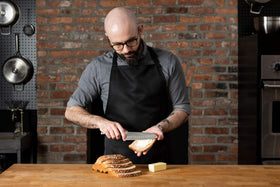 Babish Santoku in action chopping vegetables for quick prep.