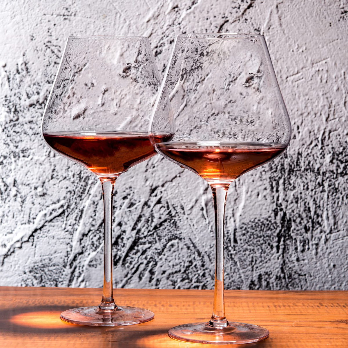 Wine glasses on a dining table by BACLIFE elevate any dinner party