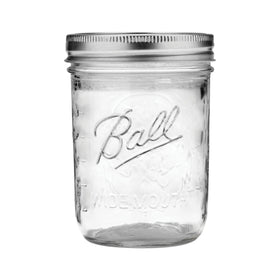 Ball mason jar close-up of clear glass and secure lid with band.