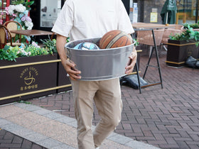 BARsics galvanized tin beverage tub in use with built-in handle.