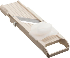 Benriner beige mandoline with handle for precise, uniform slices.