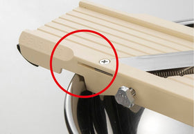 Benriner beige safety guard protects fingers during slicing.