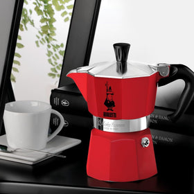 Bialetti Moka Express red handle closeup emphasizes ergonomic grip for easy pouring